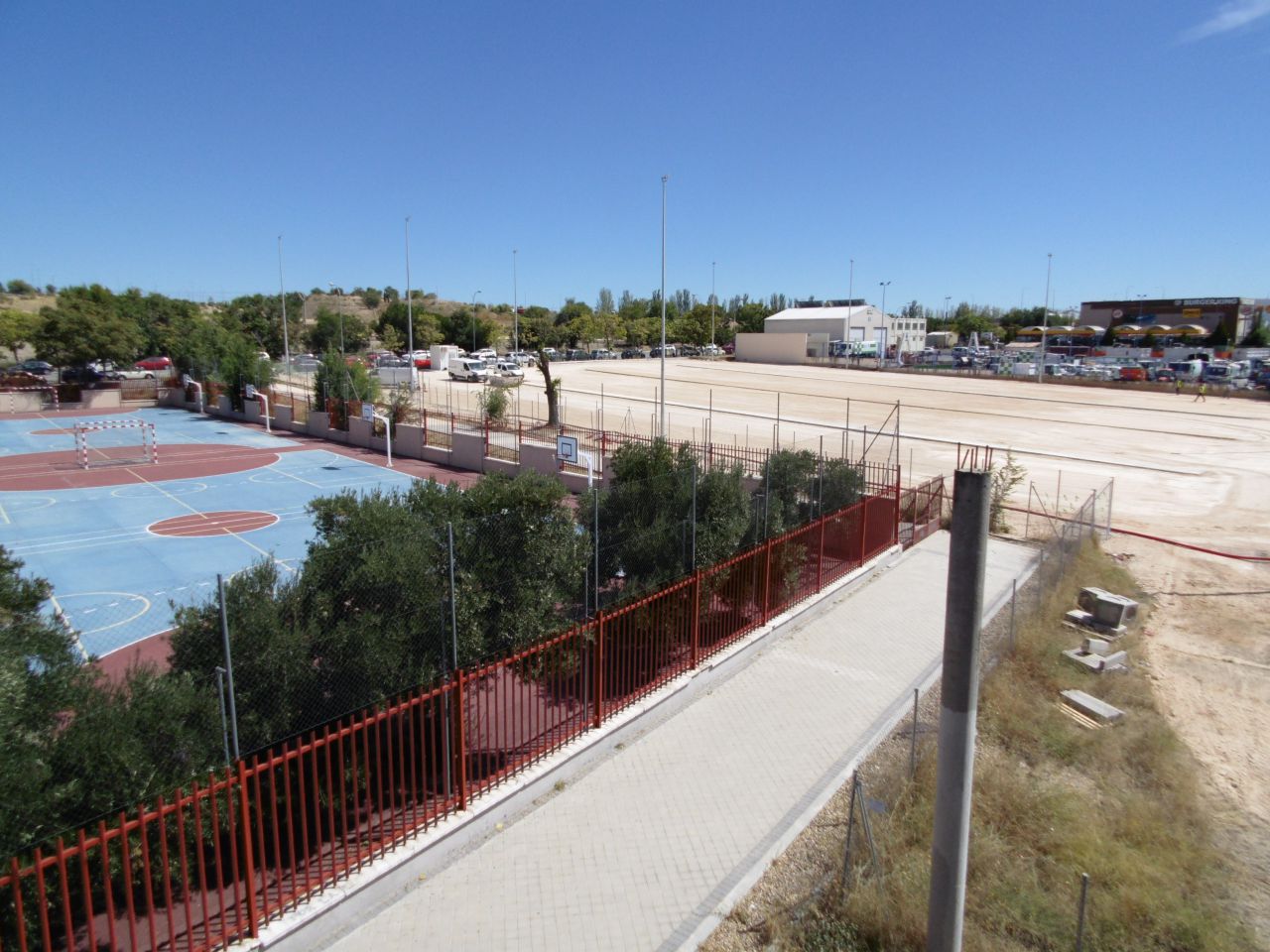 Junto al patio del colegio, el aparcamiento en obras.