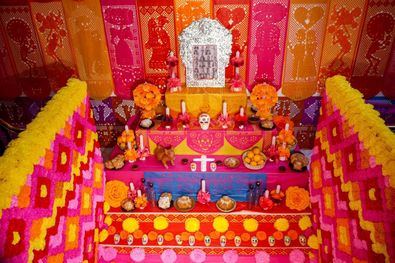 Calaveras dulces, escultura de un perro, pan de muertos, velas, flores y fotografías de los difuntos en el Mega-Altar de Muertos, dedicado este año a todos los fallecidas de Covid-19.